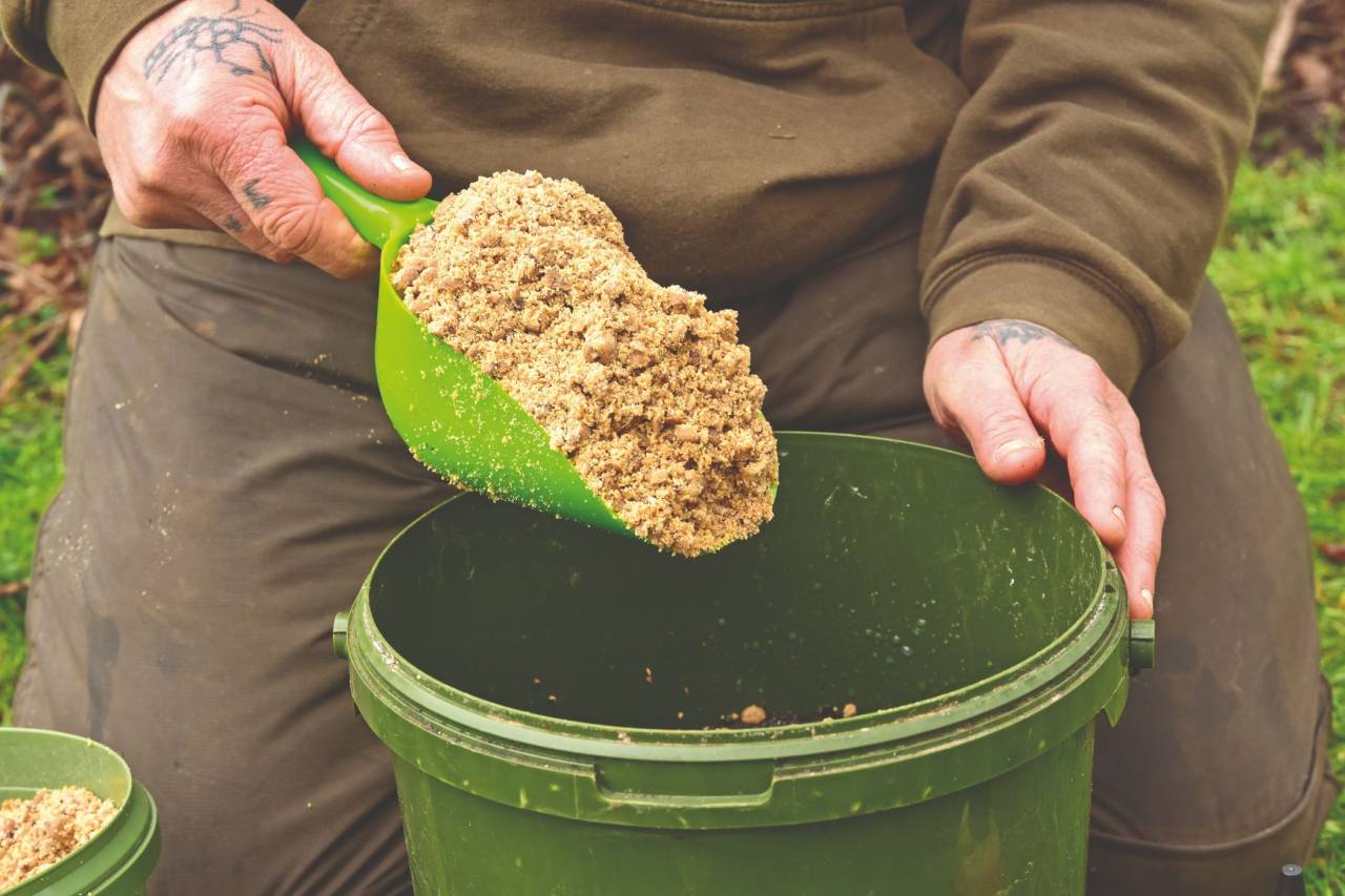 SEQ 6) Finally he adds a heaped scoop of boilie crumb Monster Tiger